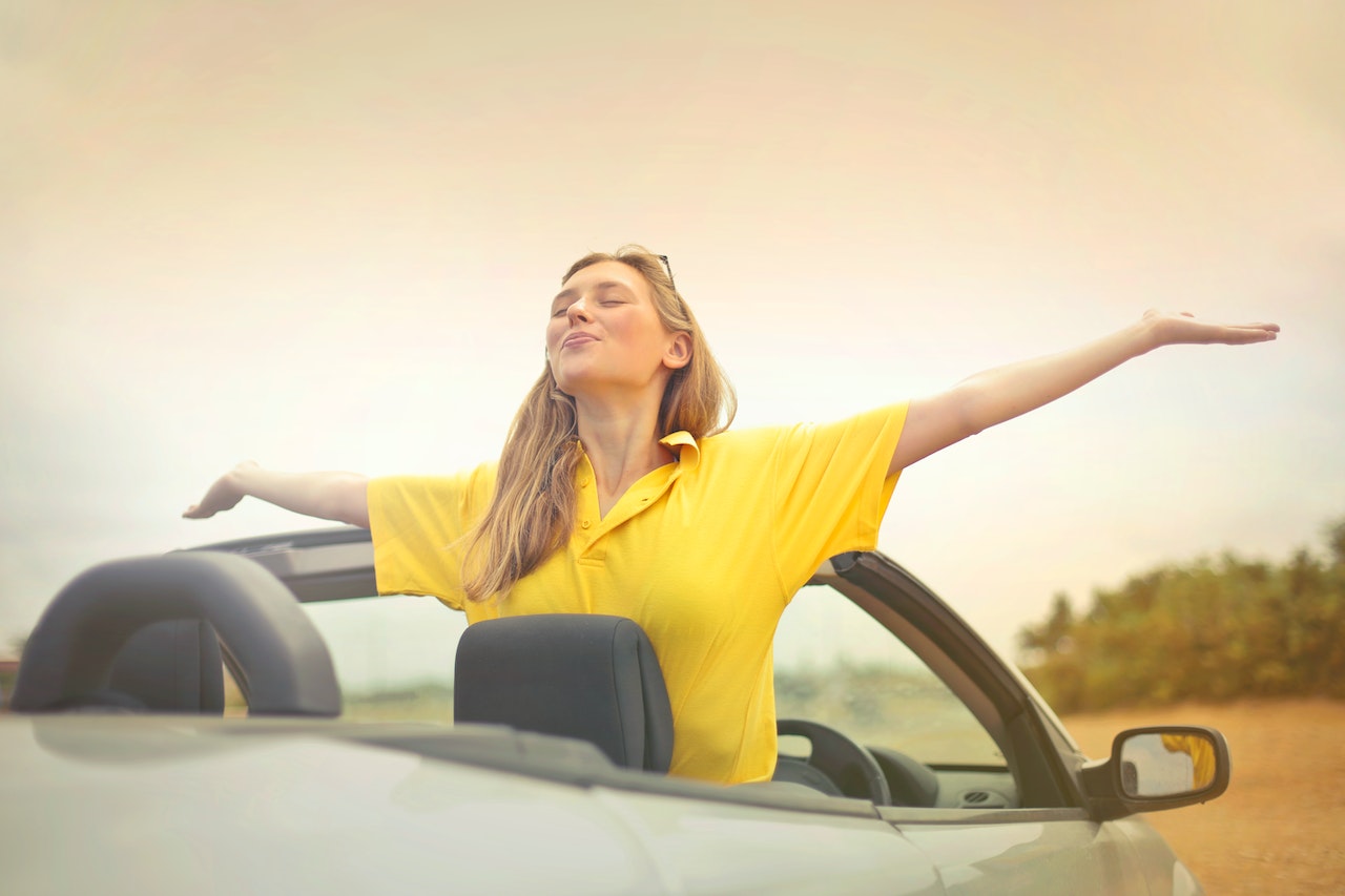 Girl is happy with her car